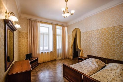 a bedroom with two beds and a television in it at Ligo Morskaya in Simeiz