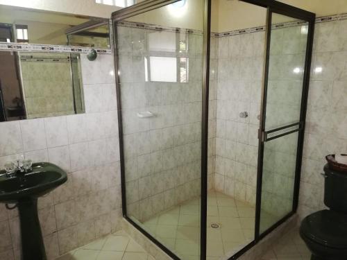 a bathroom with a shower and a sink at Hotel y Centro de Convenciones Pueblito de Yerbabuena Paraíso Natural in Chía