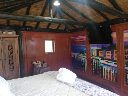 a bedroom with a bed and a tv on a wall at Hotel y Centro de Convenciones Pueblito de Yerbabuena Paraíso Natural in Chía