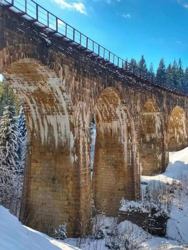 an old brick bridge with snow on it at Кришталеві вершини in Vorokhta
