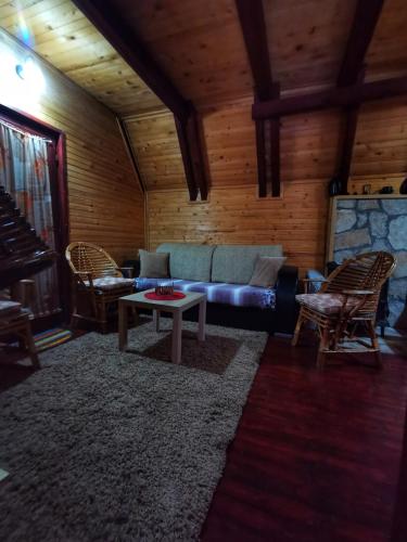 a living room with a couch and a table at Vikendica Rajsko selo in Kolašin
