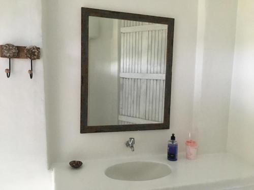 a bathroom with a sink and a mirror on the wall at Casa Eco Vila in Trancoso