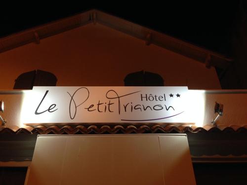 a sign for a hotel masyov on a stage at Logis Le Petit Trianon in Saint-Brevin-les-Pins