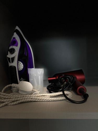 a counter top with a phone and other items on it at Duke and Duchess Apartments and Rooms - Private in Room Hot Tub Suites in London