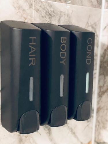 a group of three books sitting on a shelf at Duke and Duchess Apartments and Rooms - Private in Room Hot Tub Suites in London