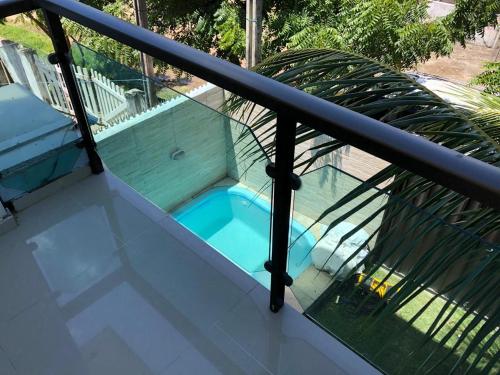 a swimming pool on the balcony of a house at CASA EM PORTO DE GALINHAS in Porto De Galinhas