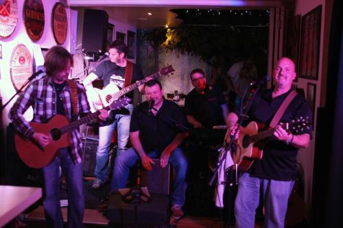 a group of people playing instruments in a room at Rhönblick Landhotel - Restaurant - Countrypub in Petersberg
