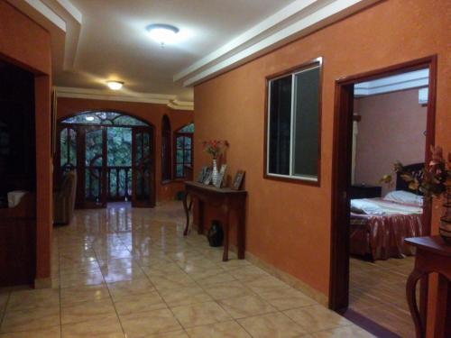 a hallway with a room with a bed and a table at Casa MONTOCO 114 in Managua