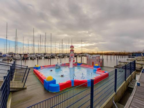 a water slide in a marina with boats at Modern Houseboat in Marina of Volendam in Volendam