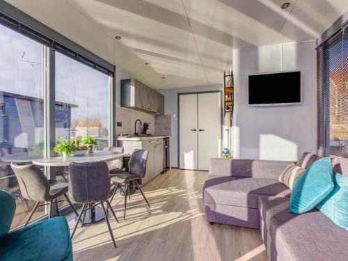 a living room with a couch and a table at Modern Houseboat in Marina of Volendam in Volendam