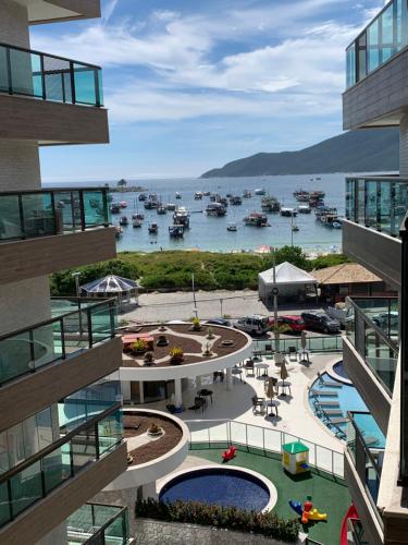 a view of a marina with boats in the water at apartamento de frente para o mar com linda area de lazer in Arraial do Cabo
