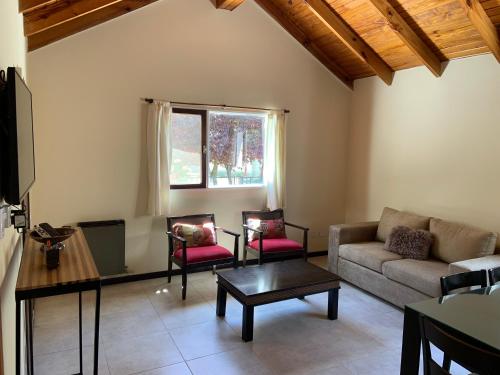 a living room with a couch and two chairs at Las Rucas in San Martín de los Andes