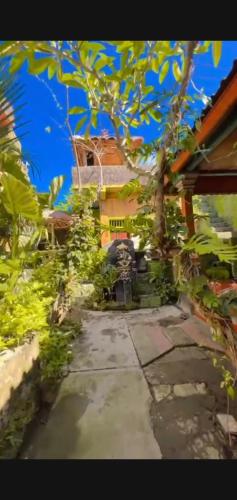 a house with a walkway in front of a building at Pondok Diana Arta in Jasri