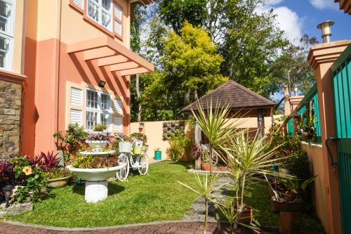 a garden with a toilet in the yard of a house at Charming Tagaytay Vacation Home in Tagaytay