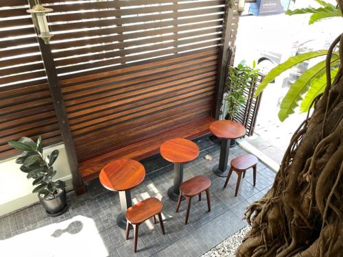 a group of stools sitting in front of a window at Rich Lanna House in Chiang Mai