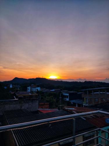 a sunset over a city with the sun setting in the distance at Nirvana Casa de Huéspedes in Melgar