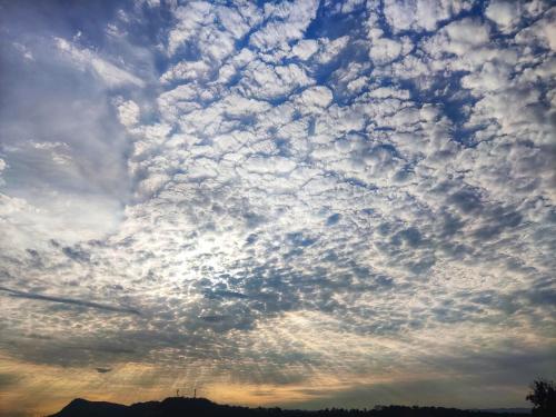 a cloudy sky with the sun poking through at Nirvana Casa de Huéspedes in Melgar