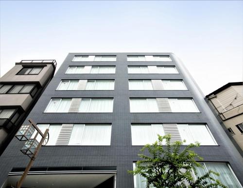 a tall gray building with many windows at B:CONTE Asakusa in Tokyo
