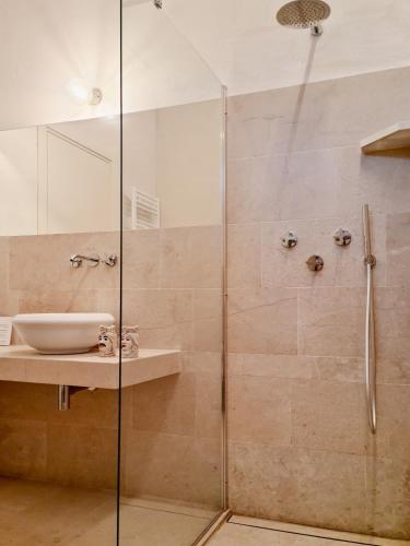 a bathroom with a shower and a sink at Relais Terre di Romanello in Noto