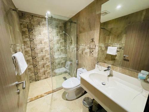a bathroom with a toilet and a sink and a shower at Terrace View Serviced Apartments 2 in Al Khobar
