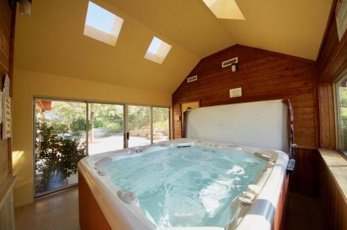 a large bath tub in a room with a window at Pack Creek ~ Creekside East in Moab