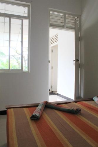a room with a door with a rug in front of it at The Sisara in Kataragama