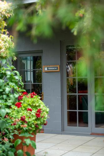 a door to a building with a sign on it at Rhyll Haven Luxury Getaway Apartments in Rhyll