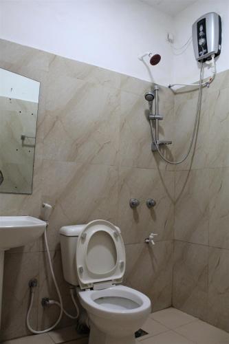 a bathroom with a shower and a toilet and a sink at The Sisara in Kataragama