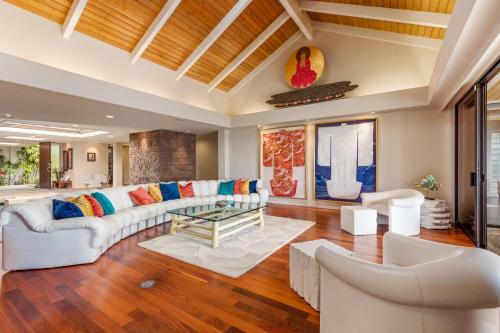 a living room with a white couch and a table at Waterfall House - Hawaii in Kailua-Kona