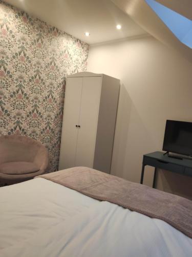 a bedroom with a bed and a cabinet and a desk at Gościnna Chata Domek in Jaworki