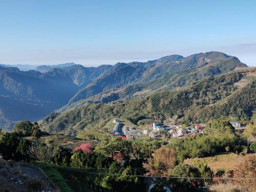 a town in a valley with mountains in the background at Song Mao Homestay in Leye