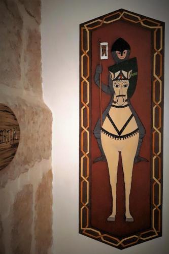 a painting of a woman on a wall at TORRE FUERTE Siglo XIII in Baños de Rioja
