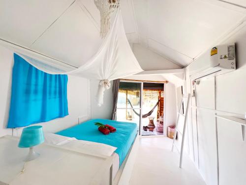 a bedroom with a blue bed in a room at Sea Love Beach Bar & Bungalows in Ban Tai