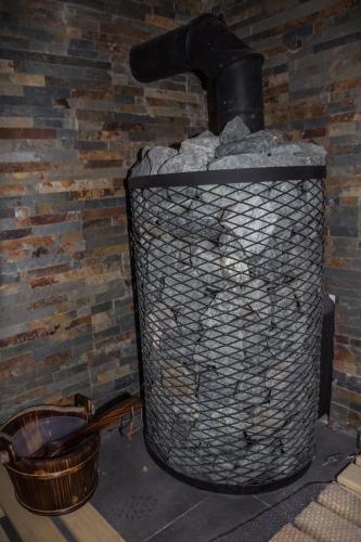 a trash can sitting next to a brick wall at Gościnna Chata Domek in Jaworki