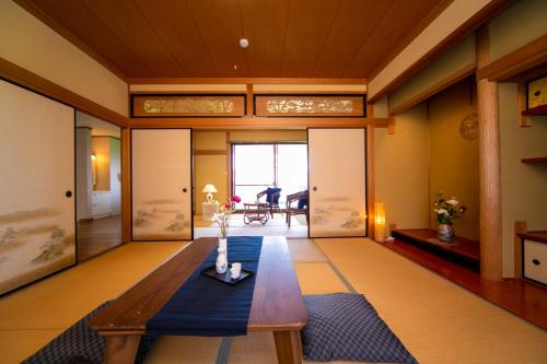 a living room with a wooden table and a blue rug at Awaji Seaside Resort in Shiduki in Awaji