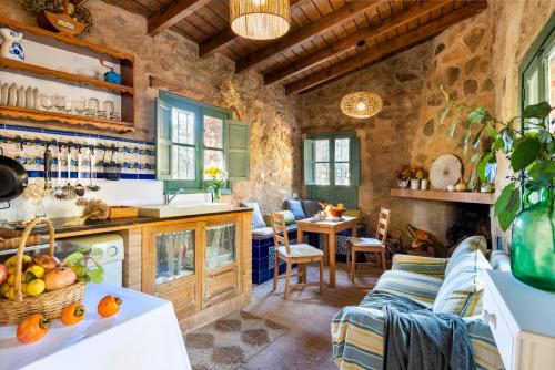 a kitchen and living room with a couch and a table at Nature Space Jabugo in Jabugo