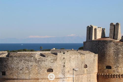 an old castle with the ocean in the background at Home Holiday Salento Monica's House Otranto in Otranto
