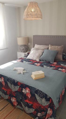 a bedroom with a bed with a box on it at Chic Home with garage Almuñecar San Cristobal in Almuñécar