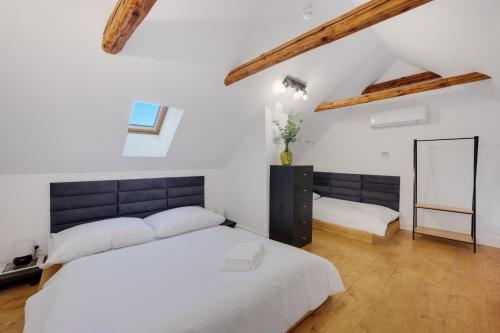 a bedroom with two beds and a mirror at Palace Apartments in Bratislava
