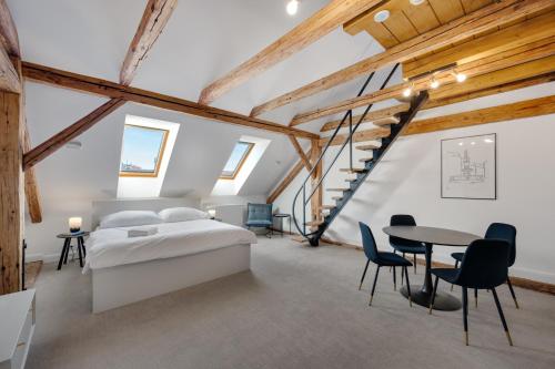 a bedroom with a bed and a table and chairs at Palace Apartments in Bratislava