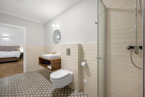 a bathroom with a toilet and a sink and a shower at Palace Apartments in Bratislava
