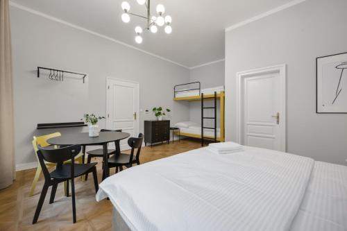 a bedroom with a bed and a table and chairs at Palace Apartments in Bratislava