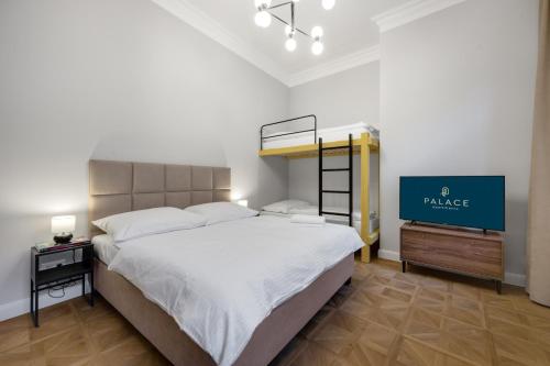 a bedroom with a large bed and a tv at Palace Apartments in Bratislava