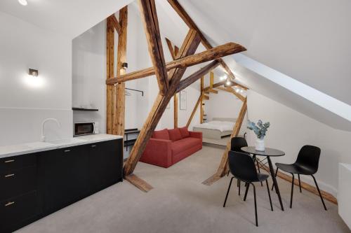 a kitchen and living room with a red couch at Palace Apartments in Bratislava