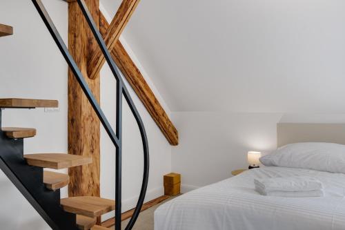 a bedroom with a bed and a spiral staircase at Palace Apartments in Bratislava