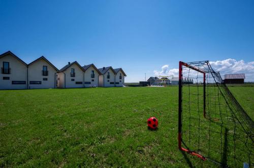 a soccer ball in a field with a goal at Chłapowska Przystań in Władysławowo