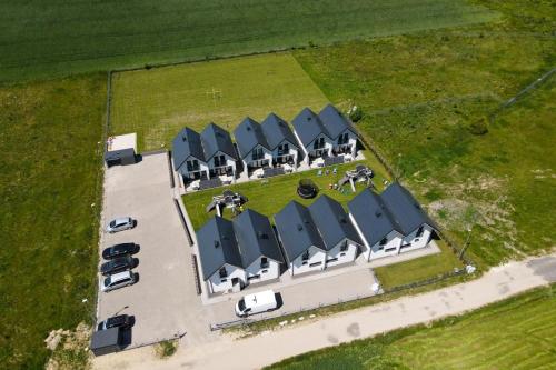 an overhead view of a building with cars parked in a parking lot at Chłapowska Przystań in Władysławowo