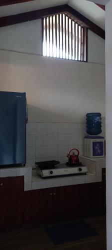 a kitchen with a stove top and a microwave at Villa Elisabeth at Villa Istana Bunga in Bandung