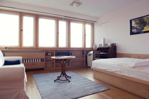 a bedroom with a bed and a table in it at Chopin Boutique in Warsaw