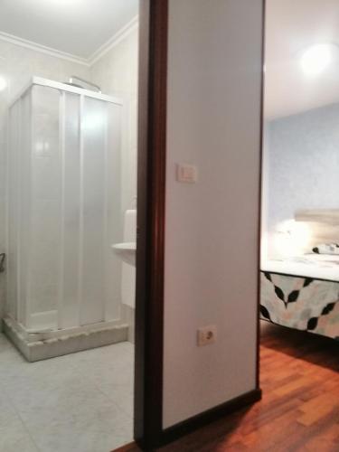 a door leading to a bedroom with a bed at Hospedaje A Goleta in O Barqueiro
